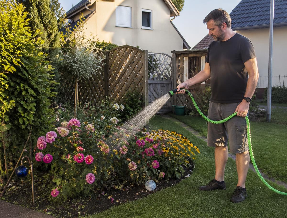 Der flexible Gartenschlauch mit Brause im Einsatz beim Bewässern